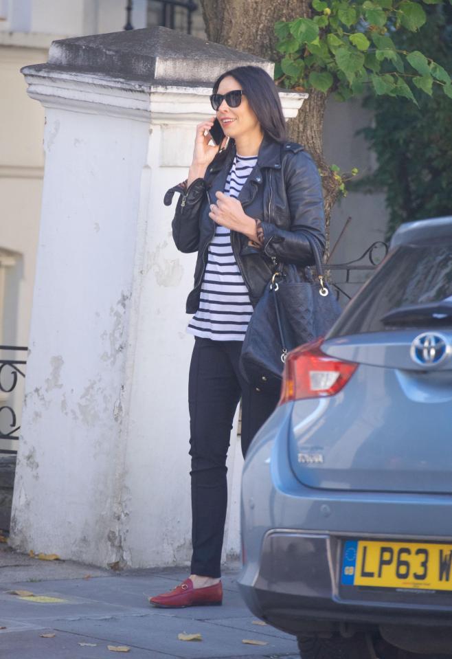  Christine was dressed down in black jeans, a stripey top, leather jacket and red loafers