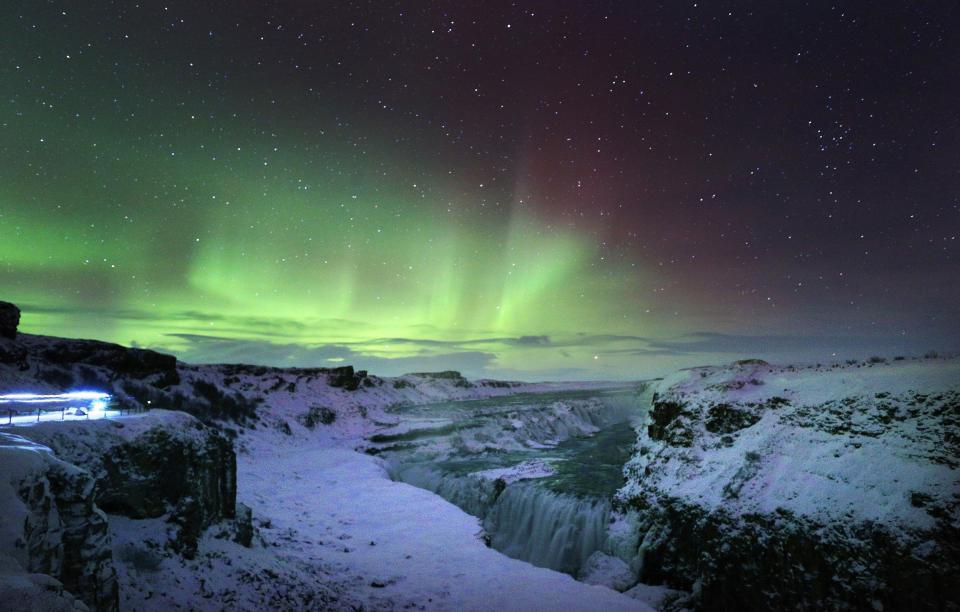  The Northern Lights visible from the Gulfoss waterfall in Iceland
