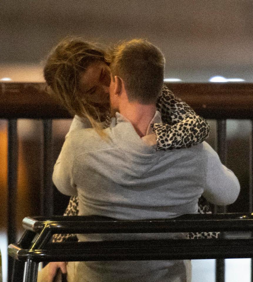 Like a pouncing big cat Ms Davies in her leopard print straddles her new man on a bench