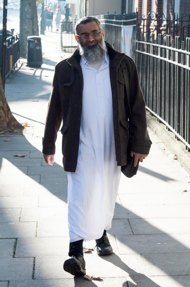 Anjem Choudary was snapped smirking as he saunters down a street with his electronic tag bulging under his sock