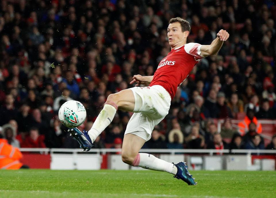Stephan Lichsteiner stretches to score his first goal for Arsenal