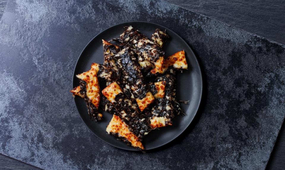 Papa John's have given their tasty garlic cheese sticks a seriously spooky make-over - by covering them in a dark black topping.
