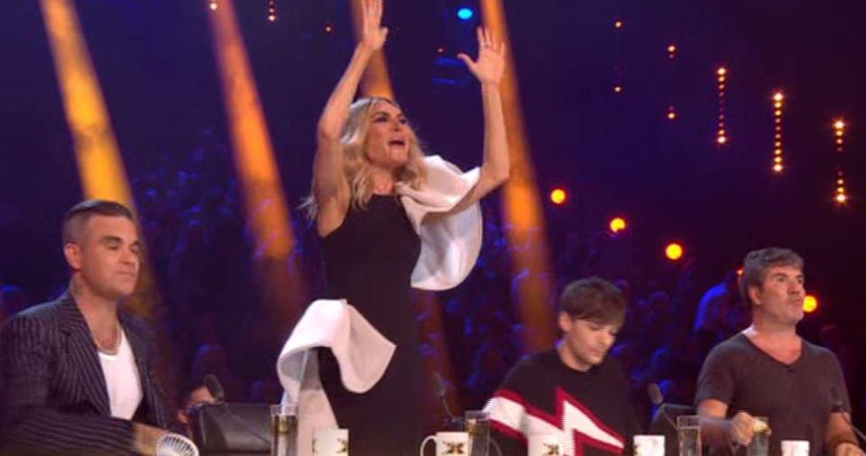  Fans got a better look at her outfit when she stood and cheered for her acts