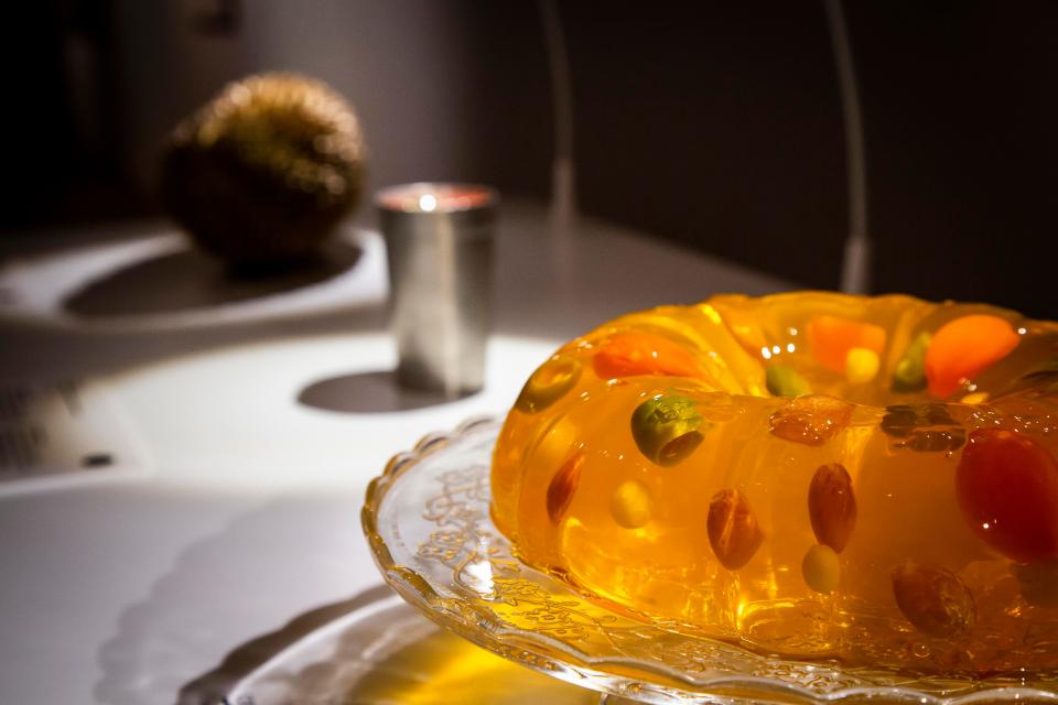 Jello-Salad includes ingredients such as tomato soup, mayonnaise, cream cheese, vegetables, sausages, olives