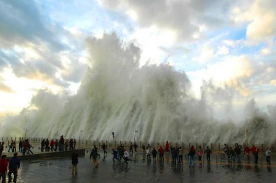 This massive waves crashed onto the promenade just feet from beachgoers who ran for their lives