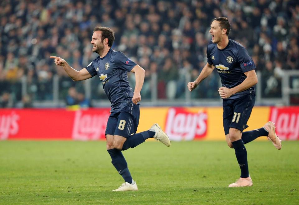  Juan Mata wheels away in celebration after pulling United level