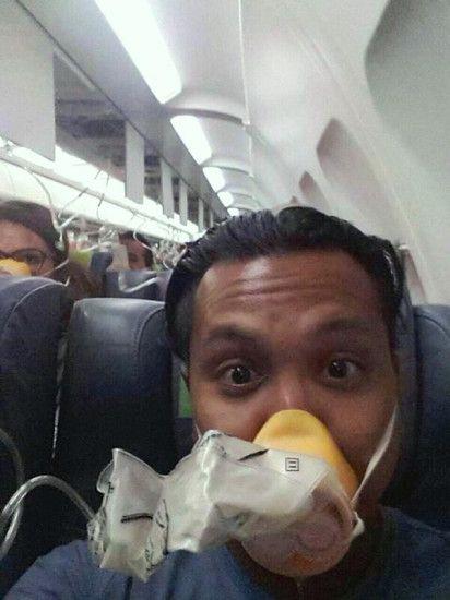  This passenger looks terrified - but he still managed to take a selfie