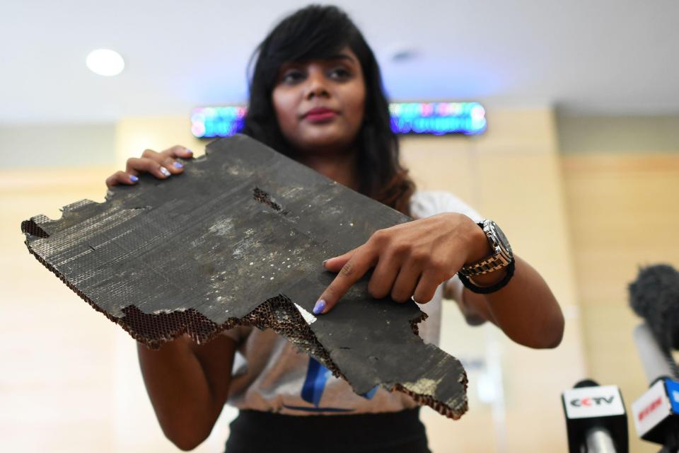  Ms Nathan points to a label that she says is still readable on a piece of debris