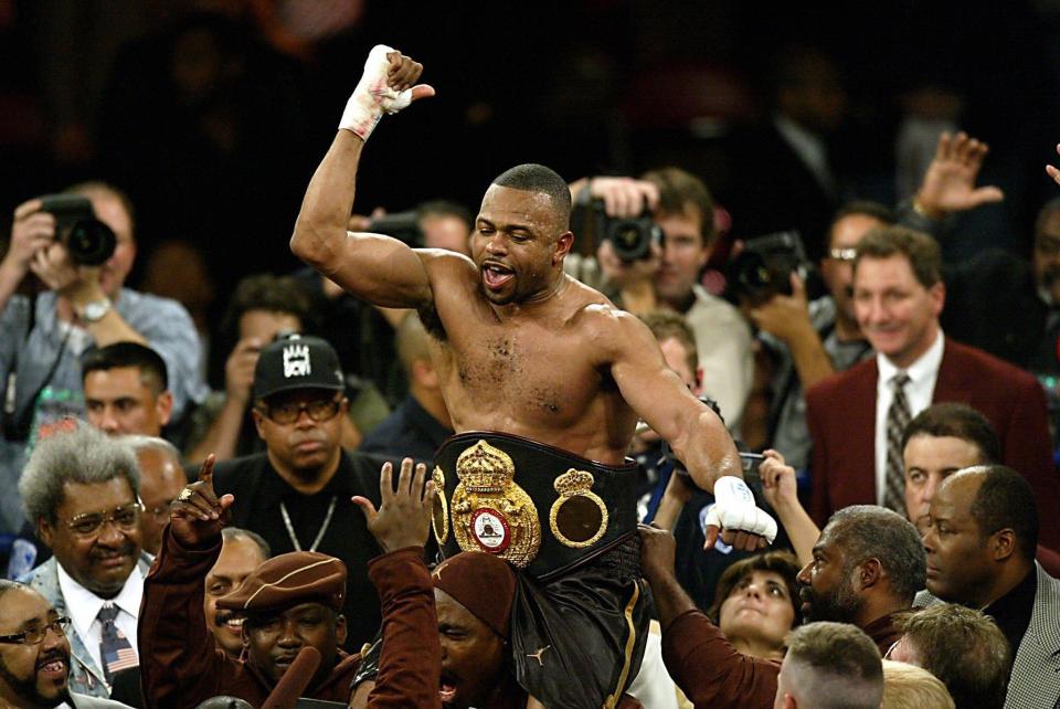 a man with a boxing belt that says o on it