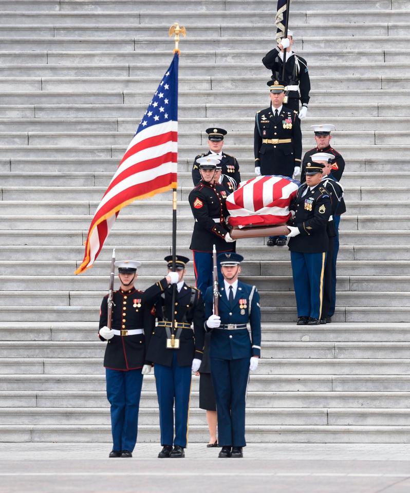  The casket is taken down the steps