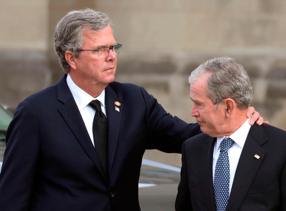  George W Bush is comforted by his brother and former Florida Governor Jeb Bush