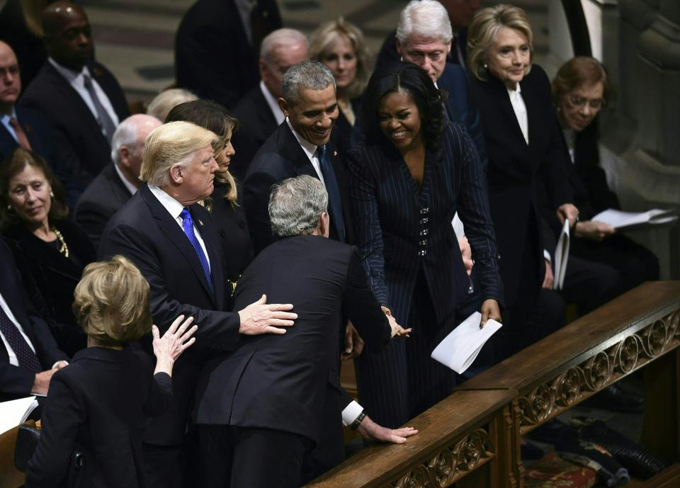  George W Bush appeared to give Michelle Obama a piece of candy after the two shared sweets at John McCain's funeral