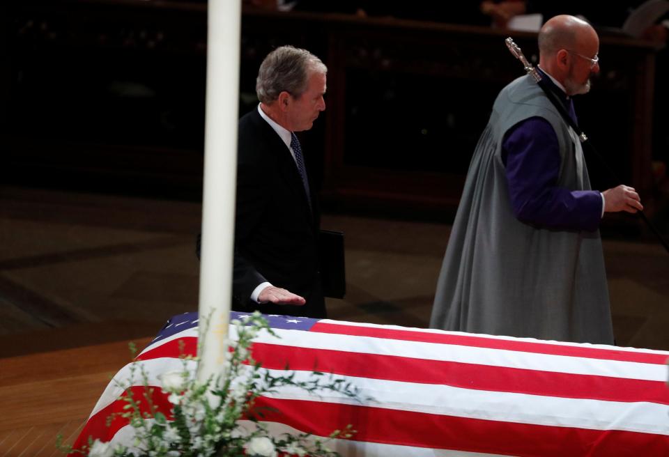  The former president touched his father's casket as he walked to deliver his eulogy at the state funeral