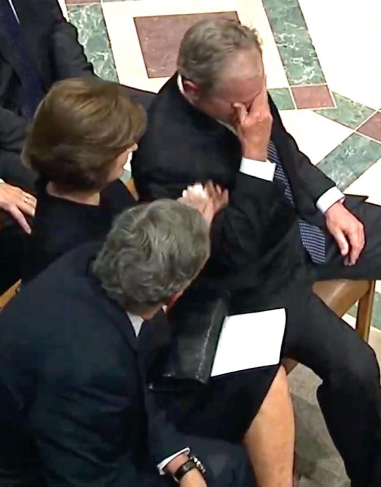  At one point it becomes too much for the former president, who covers his eyes to hold back tears