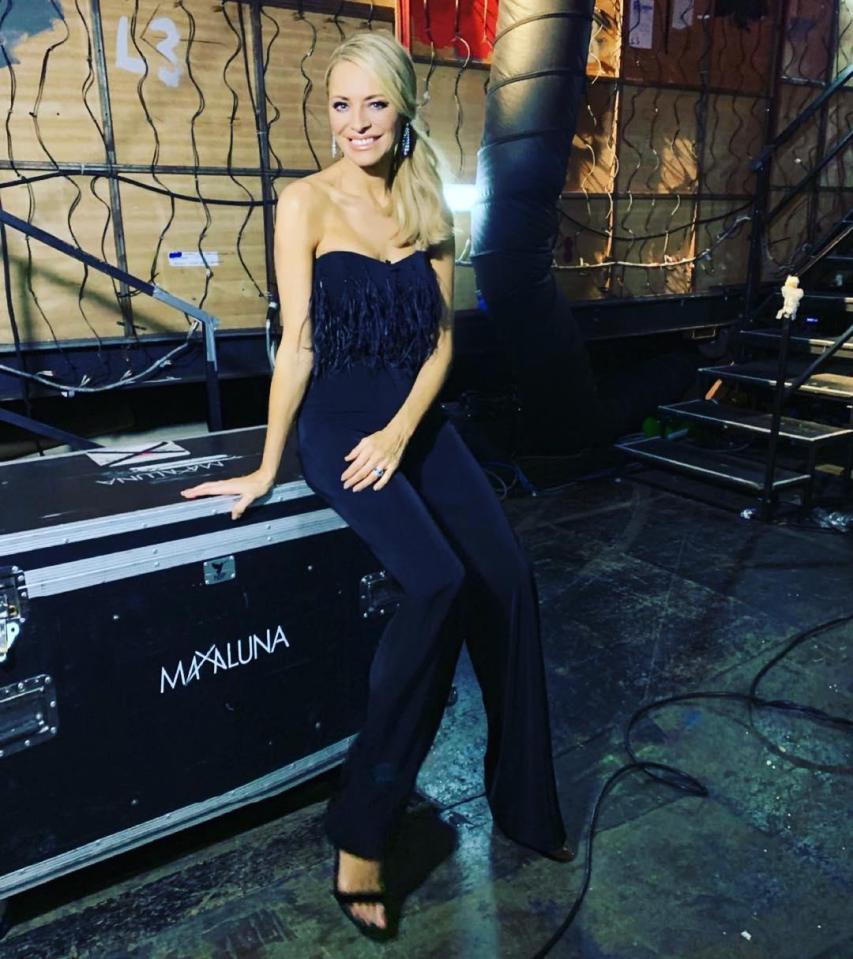  Tess stunned in a feathered, strapless jumpsuit