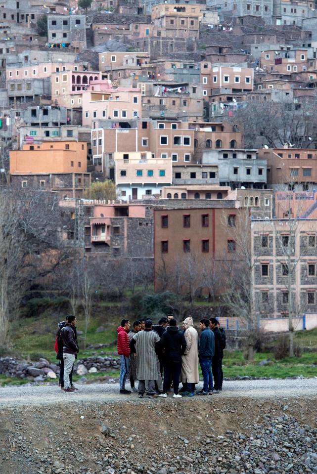 Villagers gather on a road in the tourist village of Imlil gather to discuss the murders which are rare in the remote community
