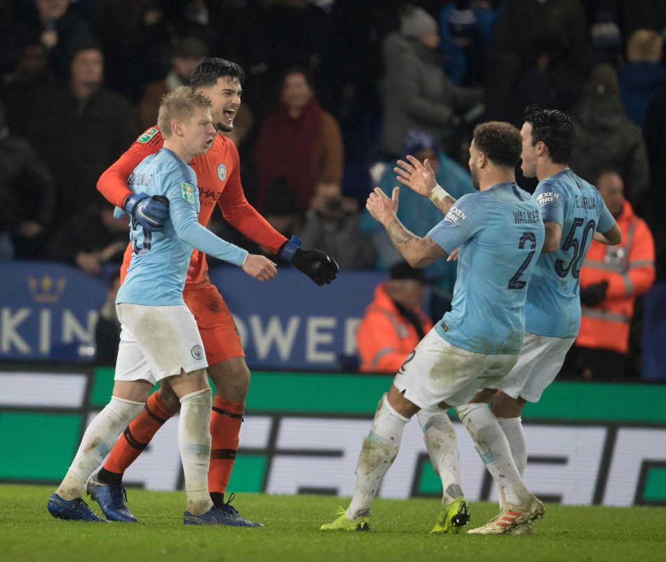 Manchester City's players rush to Aro Muric after his heroics in goal