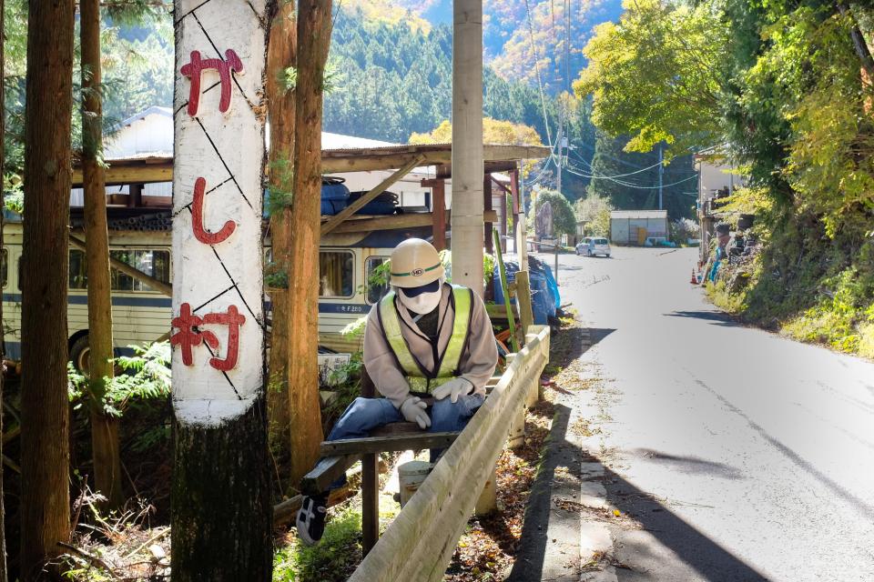  Another construction doll works on the roadside the crumbling village