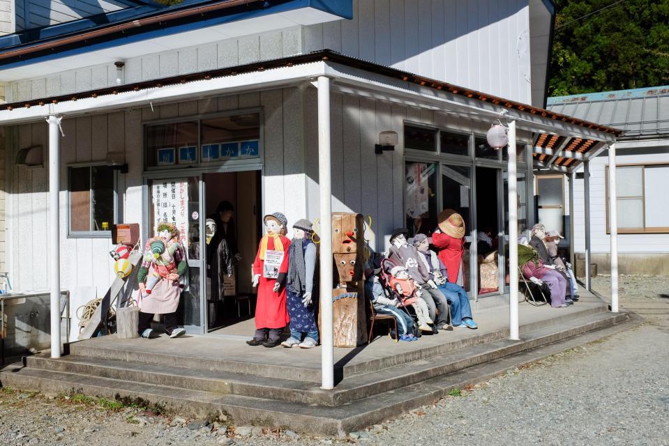  A group of dolls stand out on the porch in Nagoro