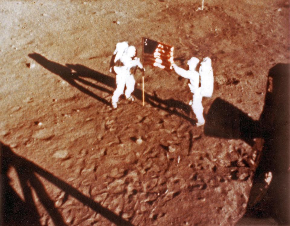 Neil Armstrong and "Buzz" Aldrin deploy the US flag on the lunar surface during the Apollo 11 lunar landing mission