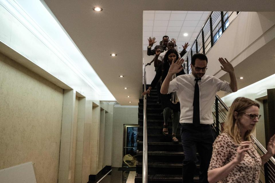People are evacuated from inside the complex