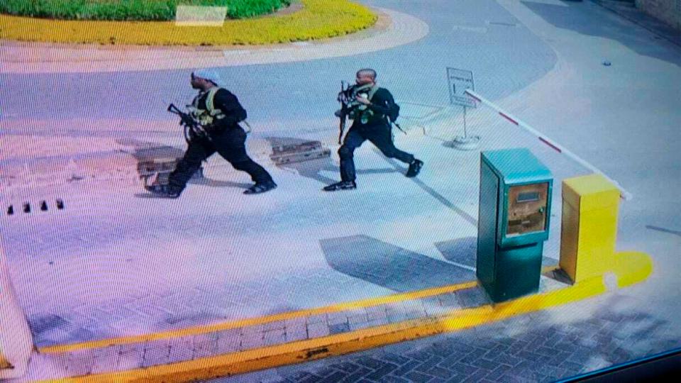 Another image shows two of the suspected gunmen stalking the hotel