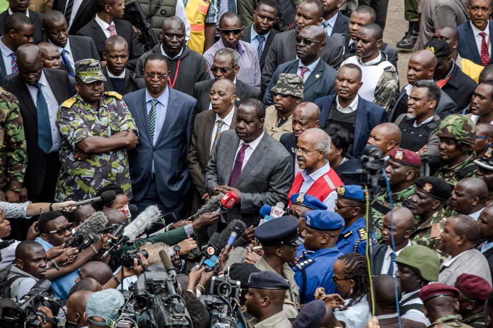  Kenyan Cabinet Secretary for Internal Security Fred Okengo Matiang'i, centre, speaks to the press at the scene