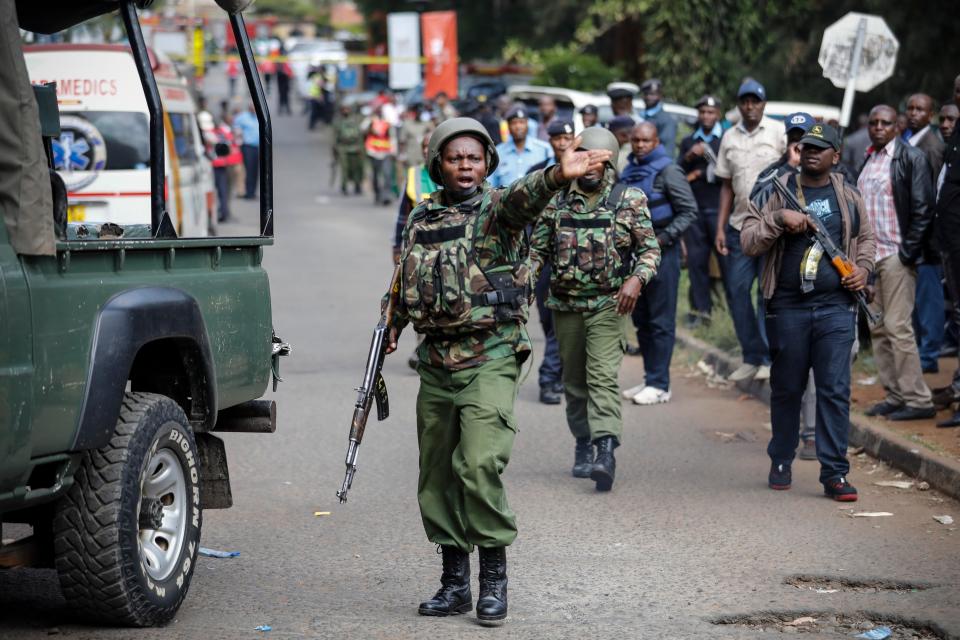  A Kenyan police officer gestures during the standoff