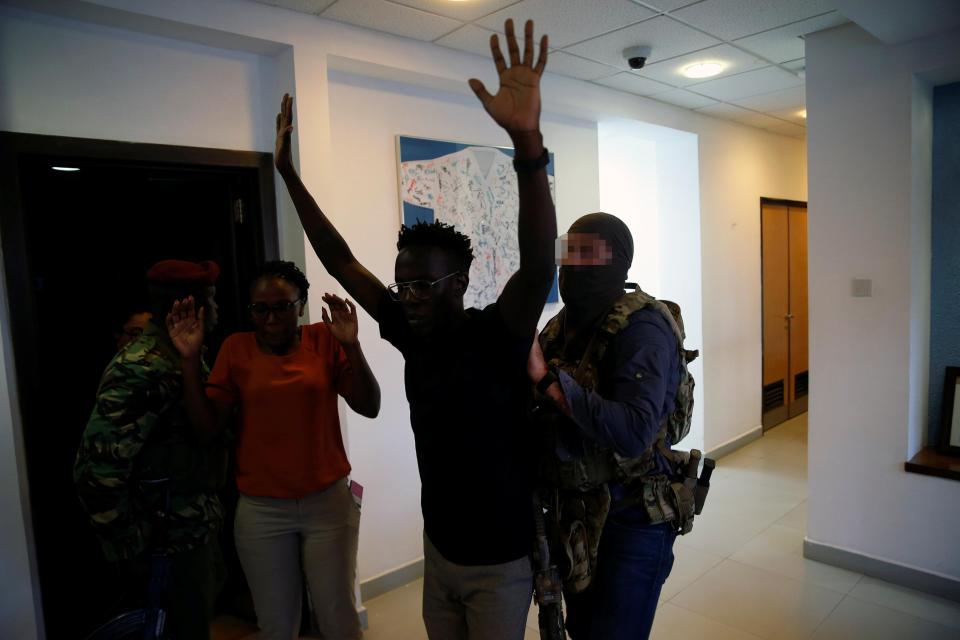 Another incredible photo shows the masked soldier escorting someone from the building