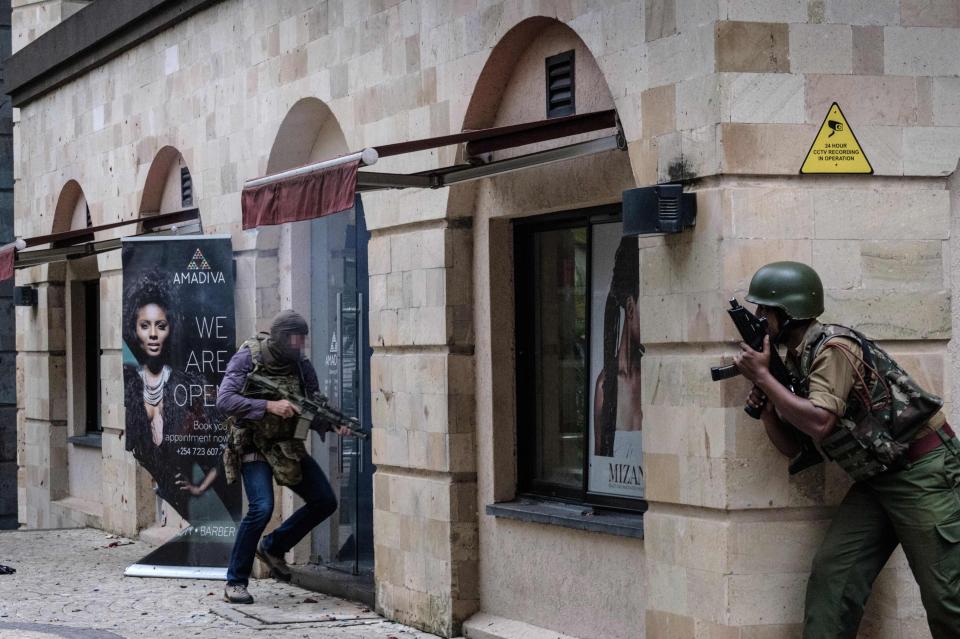 The elite soldier storms a building with his assault rifle drawn