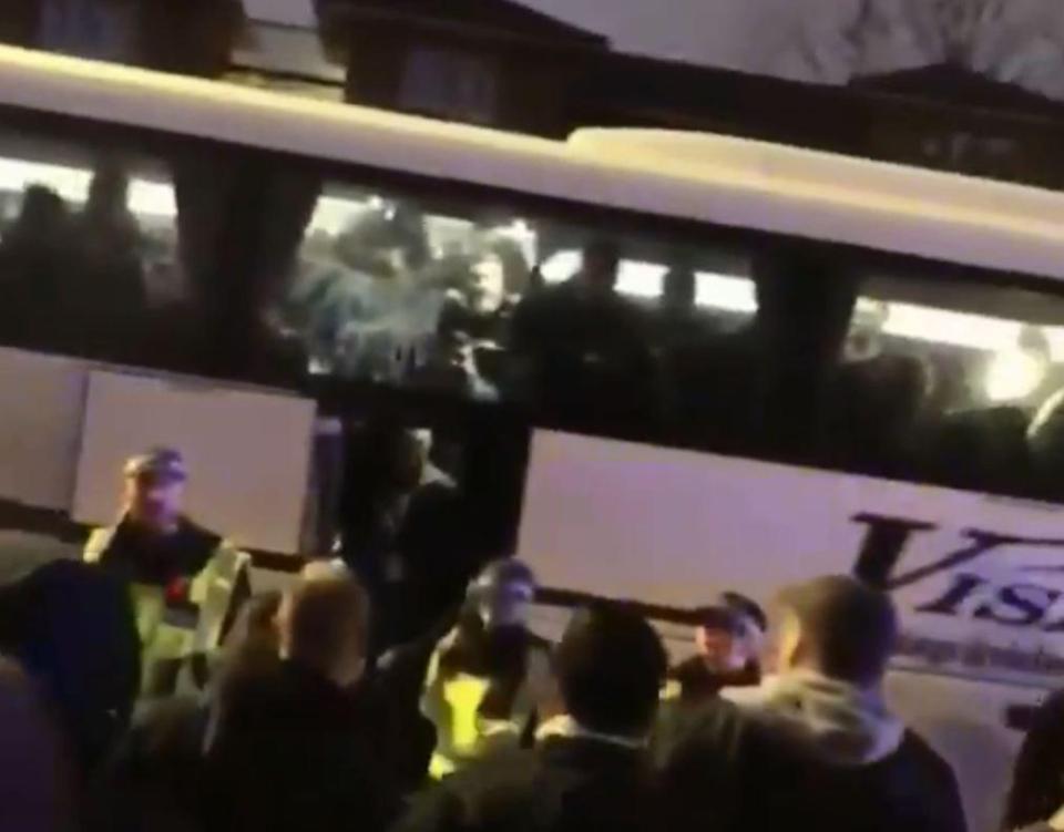  Everton fans take refuge inside a coach amid another confrontation