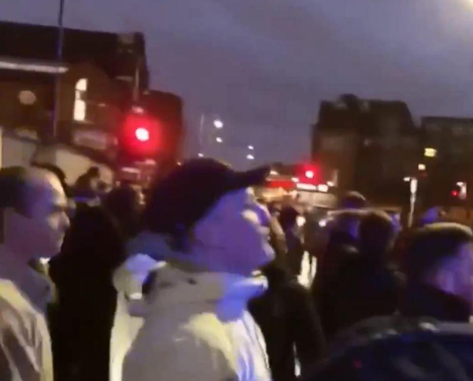  Footy fans gather around the bus containing Everton supporters