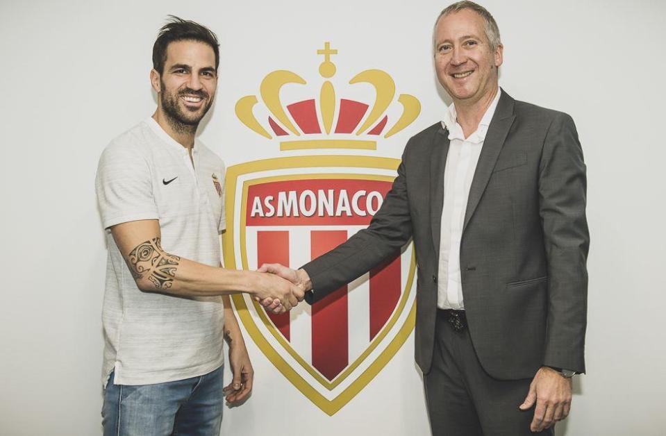 The midfielder, pictured with Monaco chief Vadim Vasilyev, has signed a deal until 2022