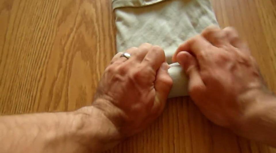  The entire T-shirt is then tightly rolled from the collar to the hem