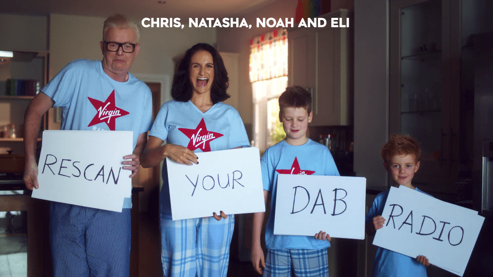  The family hold up Love Actually style boards