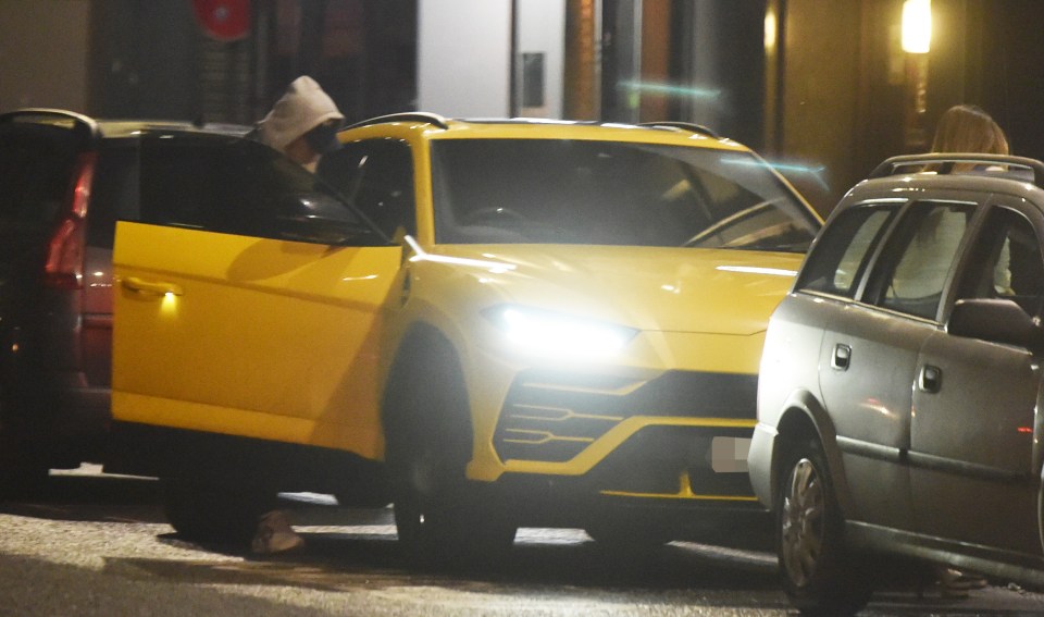  Firmino can bee seen next to his bright yellow £250,000 motor as he went out for dinner