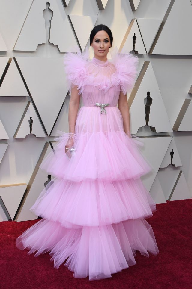  US singer Kacey Musgraves looked like a giant cake topper in this pale pink, frilly Giambattista Valli gown