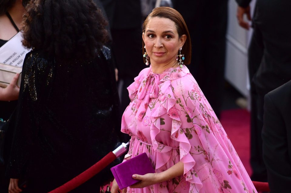  Maya's unusual pink dress had a long frilly cape in the same floral pattern