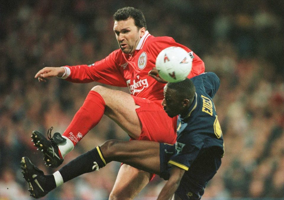 Neil Ruddock challenges goal scorer Jason Eueli during a match in May 1997