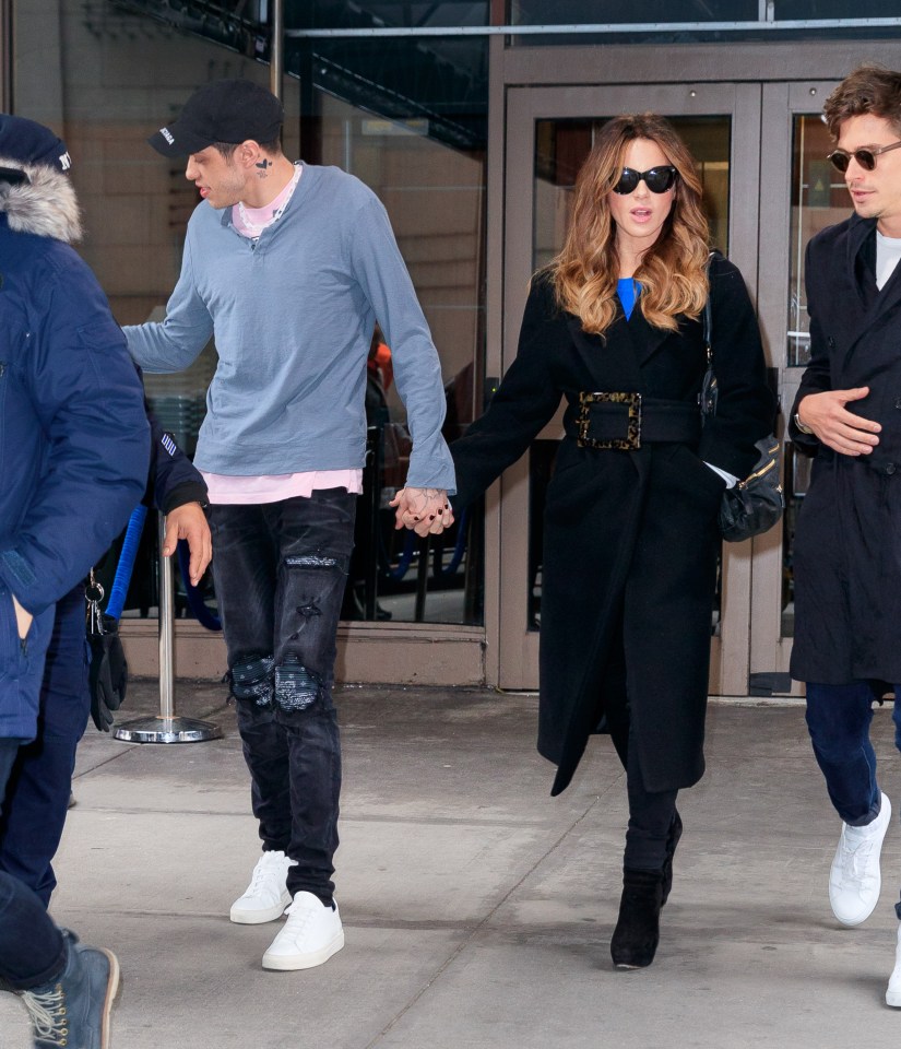  The couple held hands as they attended the ice-hockey game