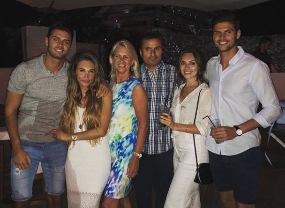 Mike Thalassitis, pictured with his family and Megan McKenna
