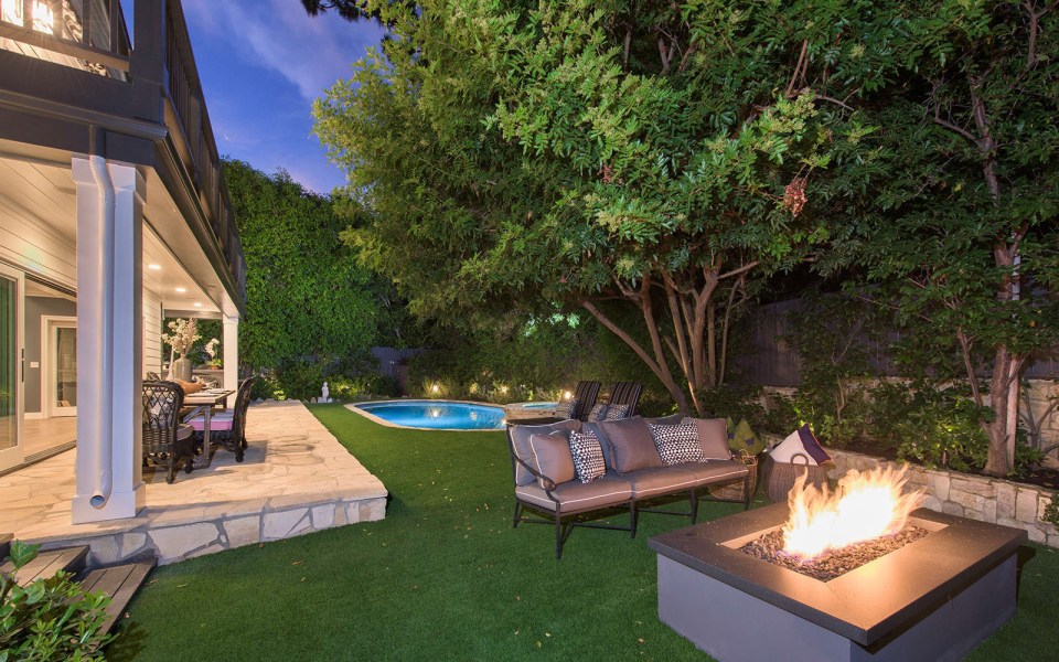 The rear garden comes complete with pool-spa area and a cozy fire pit