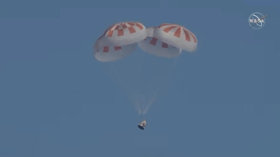  The capsule hung under four parachutes before splashing down in the Atlantic