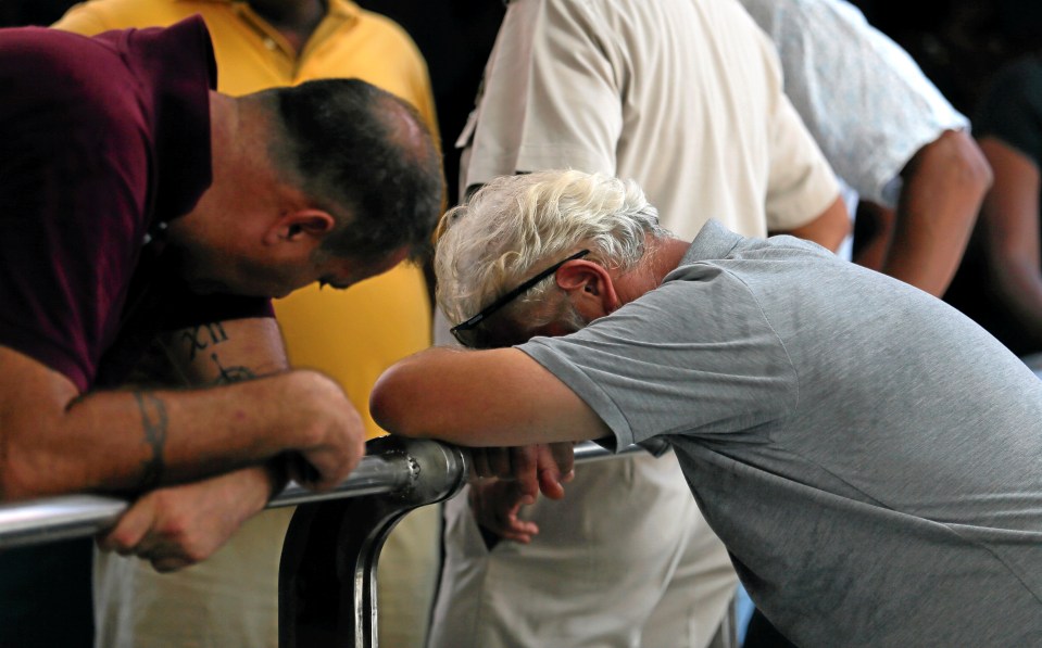 Witnesses bow their heads as they take in the devastation in Colombo this morning