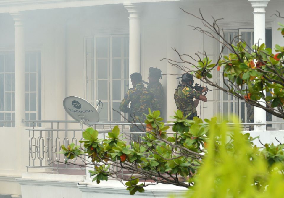  Sri Lankan Special Task Force (STF) personnel pictured outside a house during a raid