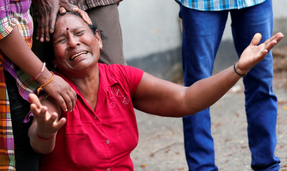  Devastated locals weep in the aftermath of the horrendous attacks yesterday morning