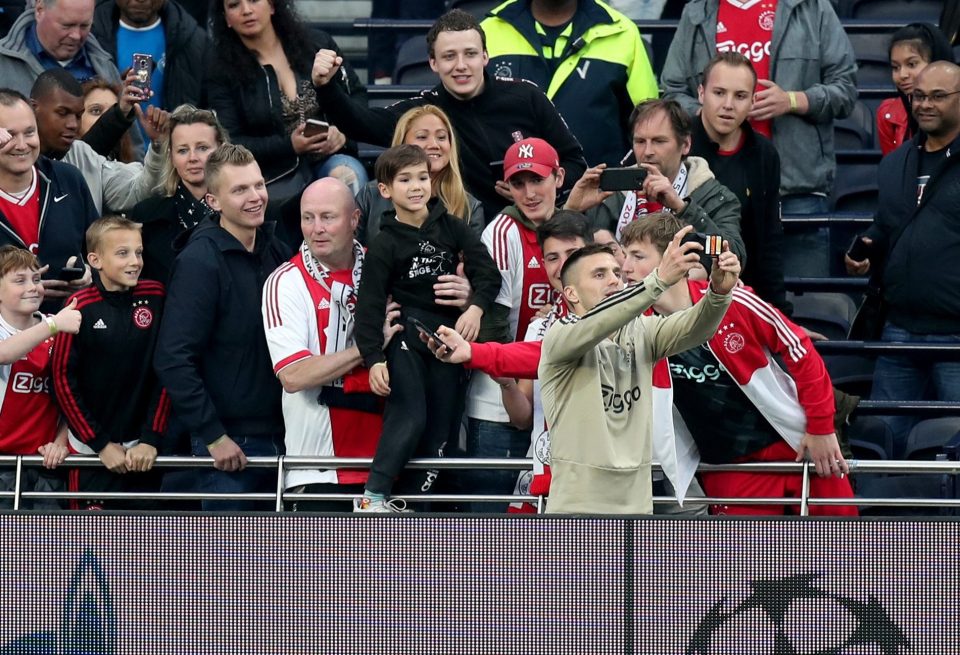 Dusan Tadic takes a selfie with some fans at training