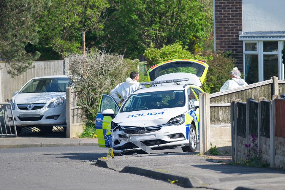 The scene on Worcester Avenue, Mansfield Woodhouse, Notts, where a damaged police car can be seen