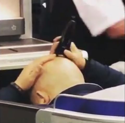 However, the attendant does nothing and continues handing out towels