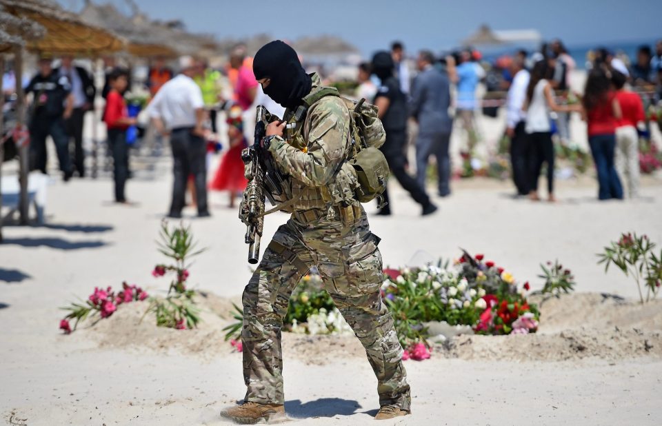  Armed guards patrol Marhaba beach on June 29, 2015 during a visit by Theresa May at the scene where 38 people were killed